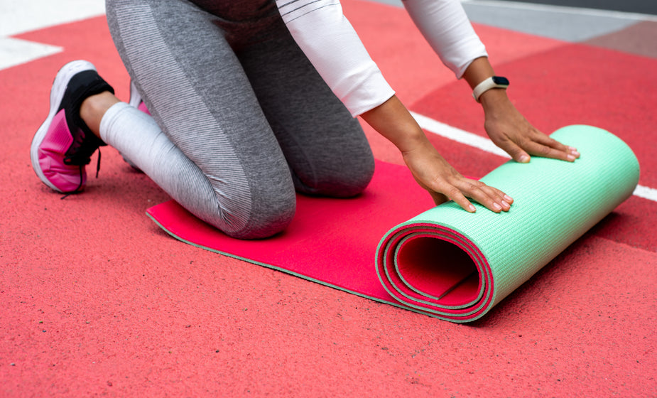 rolling out her yoga matt | Charles Janoah